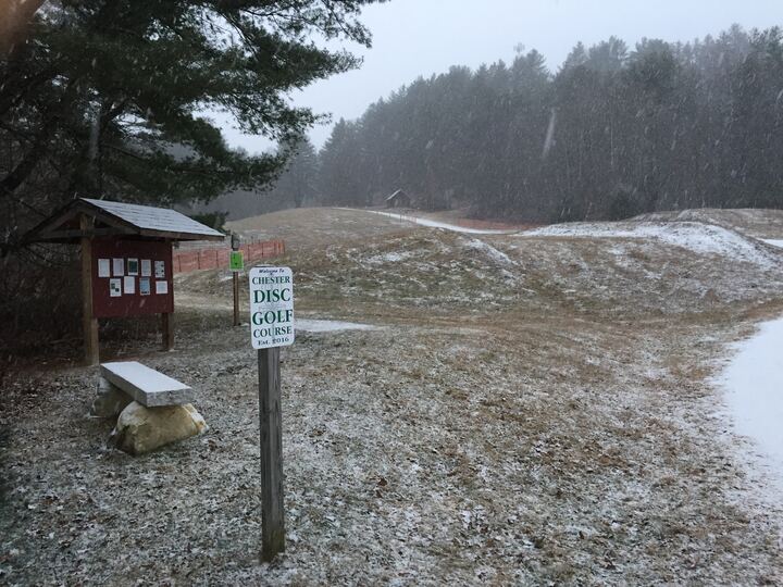 First snow covering the course entrance near a sign